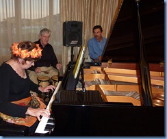 Carole Littlejohn playing grand piano with accompaniment by Ian Jackson on drums