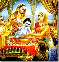 Women tending to baby Krishna