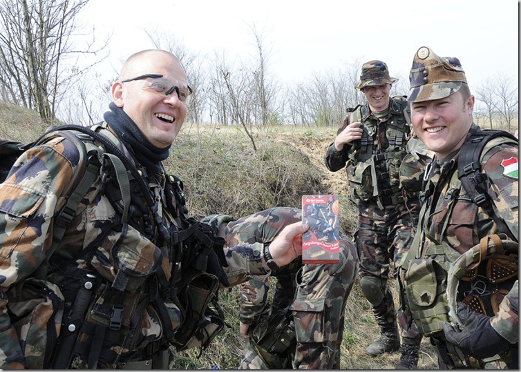 Members of the Hungarian Defense Forces (HDF) Operational Mentor and Liaison Team (OMLT) enjoy a bit of Americana, some Girl Scout cookies given to them by their US soldier friends, after mortar training, 12 April 2011, in Hungary.  
The Girls Scout cookies were sent to the US soldiers in care packages from their families.
For this OMLT, the HDF are the lead force with the 12 Army National Guard and Reserve soldiers, representing many different communities from Ohio, providing combat medics, engineers and Joint Fires Observers expertise.   
Ohio soldiers have been partnered with the Hungarian forces since 1993 and this represents the sixth OMLT that these forces have trained for.   The OMLT,  (pronounced “omelette”), is a multidisciplinary group of experienced soldiers that train for a mission where they are embedded with the Afghan National Army (ANA) to provide training, mentorship and liaison services.  (US Army Europe photo by Richard Bumgardner)
