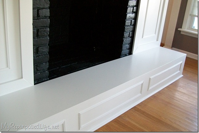 Brick Fireplace Makeover - My Repurposed Life® How to update an old brick fireplace with some lumber and paint. I