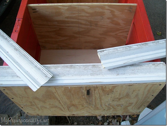 add-trim-bookshelf-repurposed-door adding trim to repurposed door book shelf