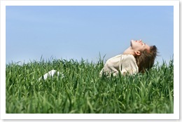 young girl relaxing in green grass
