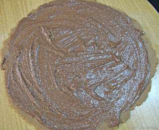Spreading Chocolate Cream on rolled Biscuit Dough