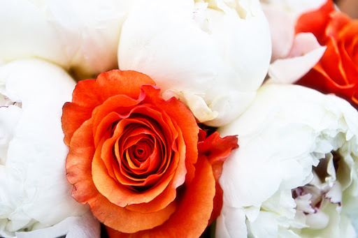 The wedding colors were orange aqua and white The deep orange roses and 