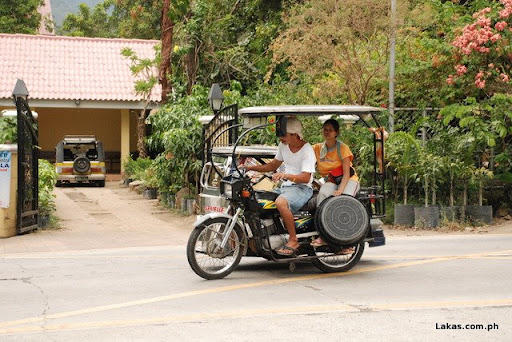Tricycle passing by Tanauan-Talisay National Road