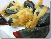 Century Eggs with pickled ginger garnish.