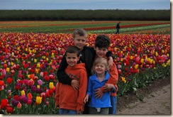happy kids in front of tulips