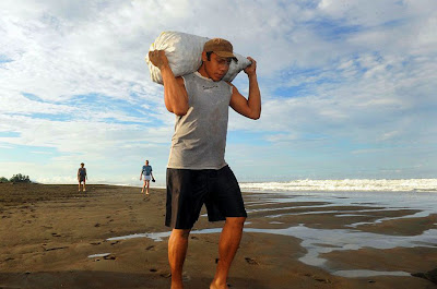 Man Carrying A Sack Filled With Turtle Eggs