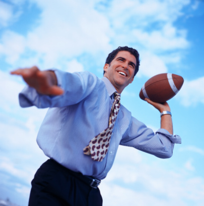 Make a touch down with the help of fast payday loans. business man about to throw a football.