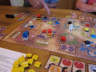 The board late in the game with a strategic hand pointing out the towers
