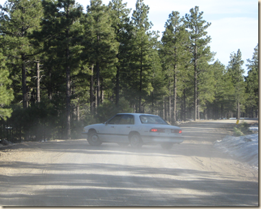car turning in dust cropped
