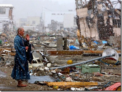 A Buddhist priest prays for the souls of the victims still not found in the rubble, Yamada, Japan. 