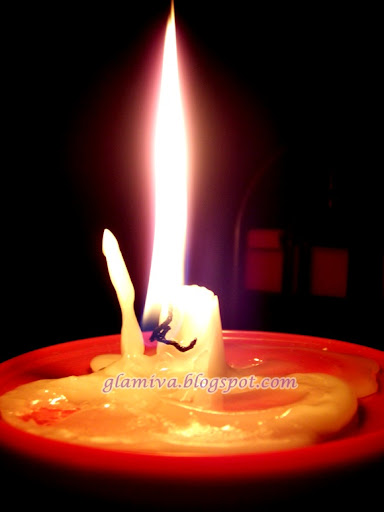 candle burning big flame in dark