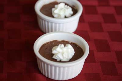 photo of two chocolate mousse topped with whipped cream