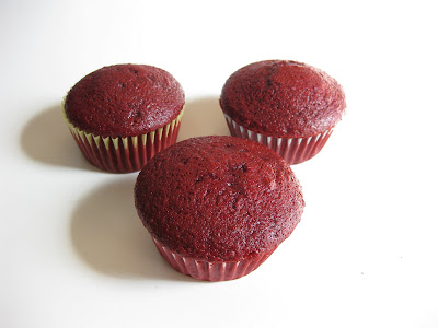photo of three red velvet cupcakes
