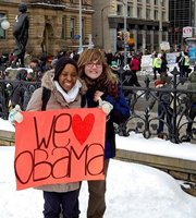 Two women hold 'We Love Obama' sign