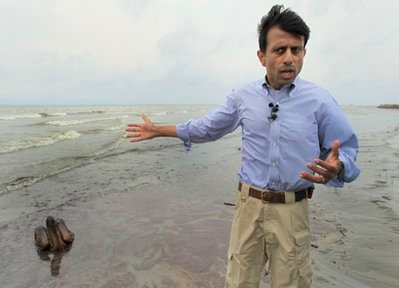 Louisiana Gov. Bobby Jindal talks to the media in front of a Brown Pelican mired in oil on the beach at East Grand Terre Island along the Louisiana coast, Thursday, June 3, 2010. AP Photo / Charlie Riedel