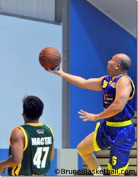 The Ambassador going for a lay-up during a basketball tournament.