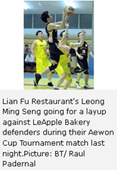 Lian Fu Restaurant's Leong Ming Seng going for a layup against LeApple Bakery defenders during their Aewon Cup Tournament match last night.Picture: BT/ Raul Padernal 