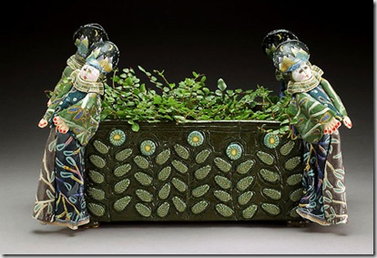 This piece is 8 - 9 tall. It faces both ways. I think it could work as a centerpiece for your table.