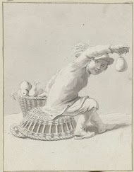 Op een mand zittend kind met een peer in zijn hand