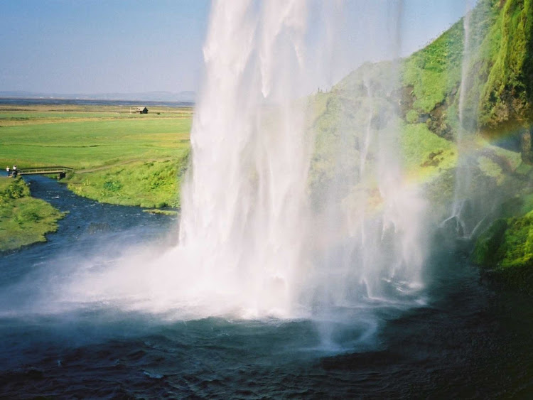 Photo taken from behind Seljalandsfoss, a spectacular waterfall in Iceland. 