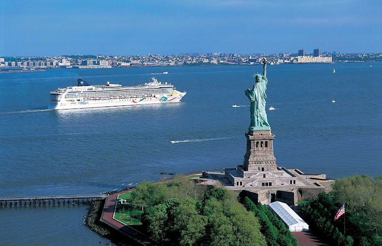 Norwegian Dawn cruising by the Statue of Liberty in New York.
