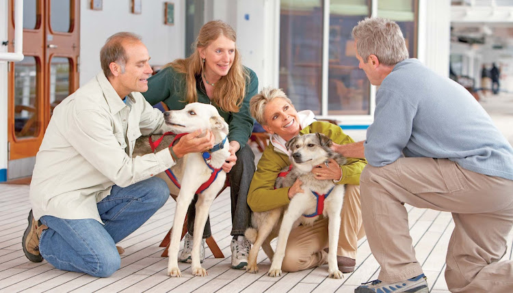 On some Princess Cruises itineraries, guests get an exclusive opportunity to hear Libby Riddles, second from left, as she recounts her journey to become the first woman Sled Dog Race champion.