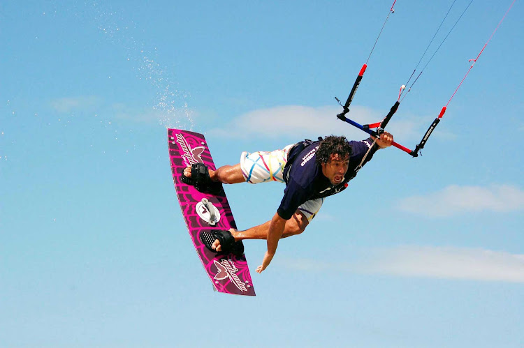 A kiteboarder catches some air along the coast of Mexico. Try it or just watch at Morph Kiteboarding in Tulum or El Cuyo, Yucatán. 