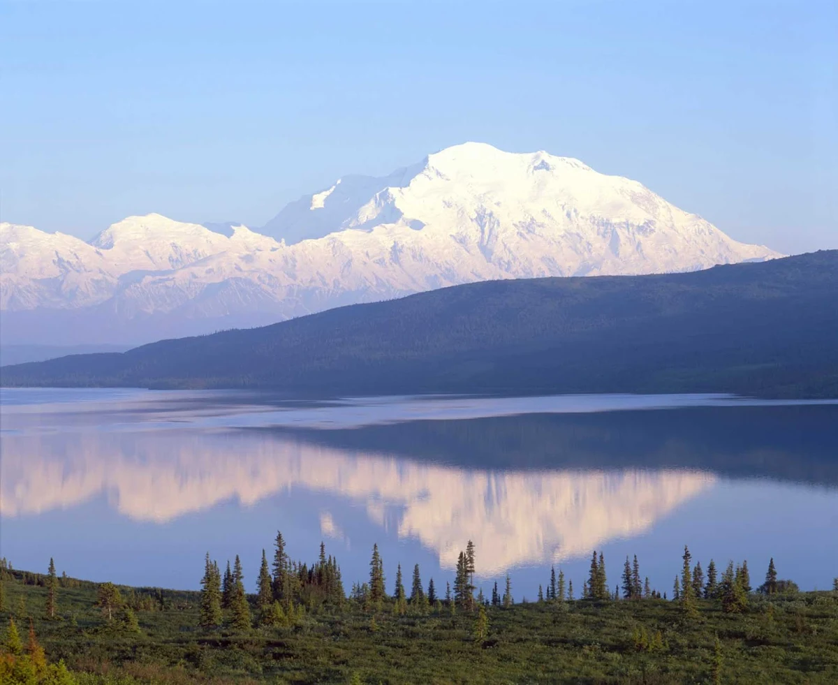 snow-mountain-lake-Denali - The magnitude of the snow-capped peaks reflect in this lake in Denali National Park, Alaska.