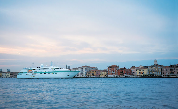 Paul Gauguin Cruises' small luxury ship Tere Moana sails through the Grand Canal of Venice, Italy, at dusk.