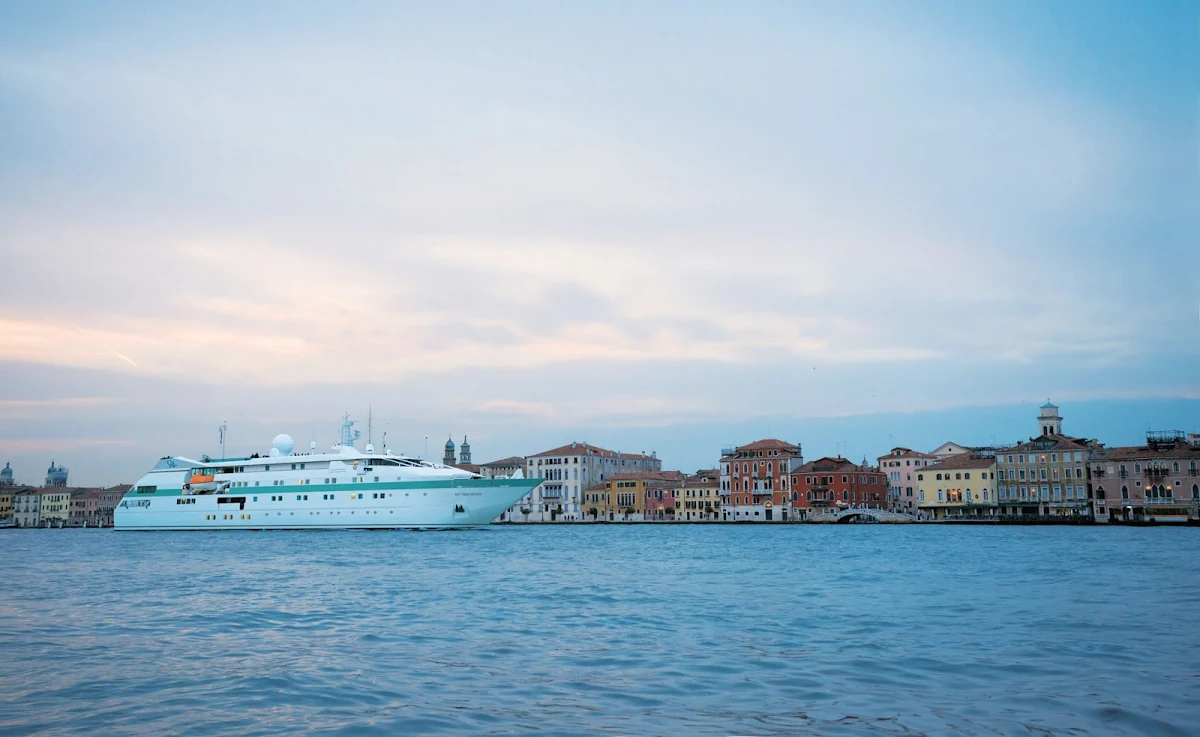 Tere-Moana-Venice-Grand-Canal - Paul Gauguin Cruises' small luxury ship Tere Moana sails through the Grand Canal of Venice, Italy, at dusk.