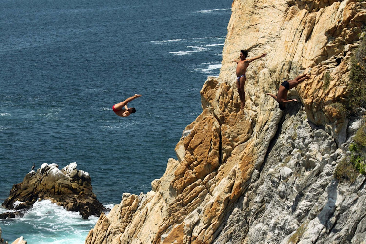 The famed cliff divers (clavadistas) doing their thing — including a triple somersault — at La Quebrada in Acapulco, Mexico.