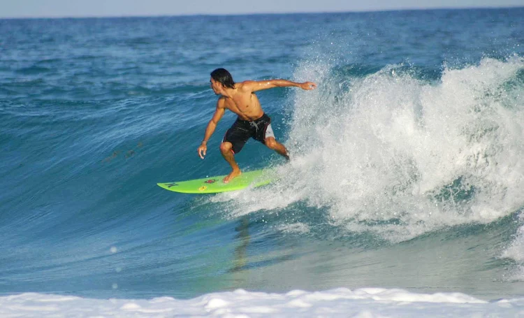 Surfers enjoy the wicked waves and laid-back style of Cozumel.