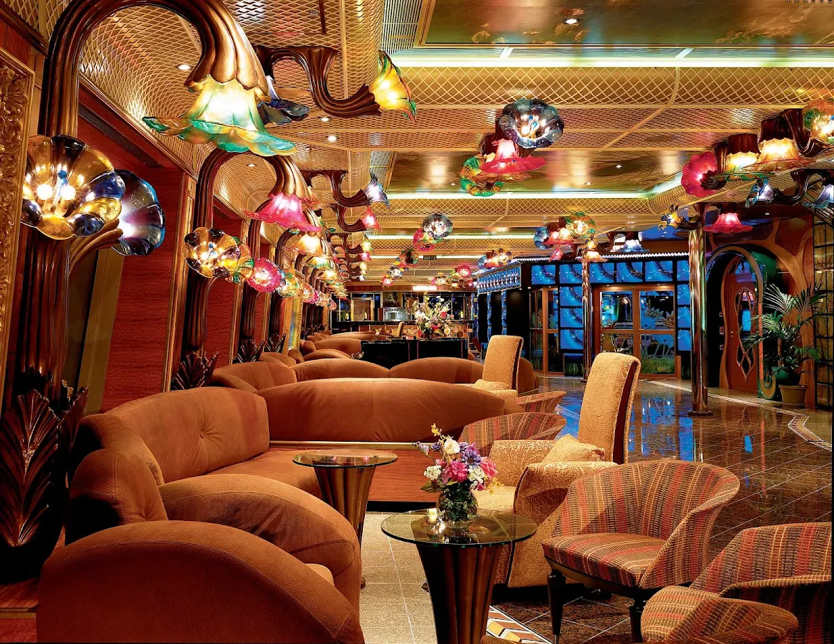 Carnival-Conquest-Impressionist-Boulevard - There's plenty of seating along Impressionist Boulevard, Carnival Conquest's indoor promenade, to meet friends or take in the ocean views.