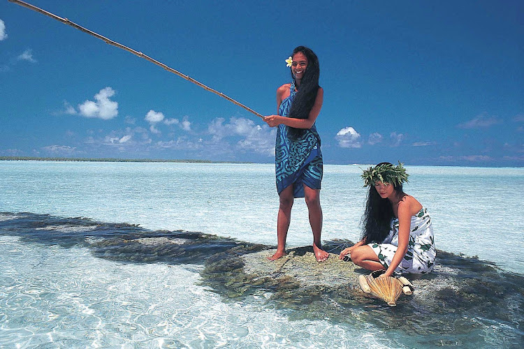 Women fish in Fakarava in the Tuamotu atolls of French Polynesia.