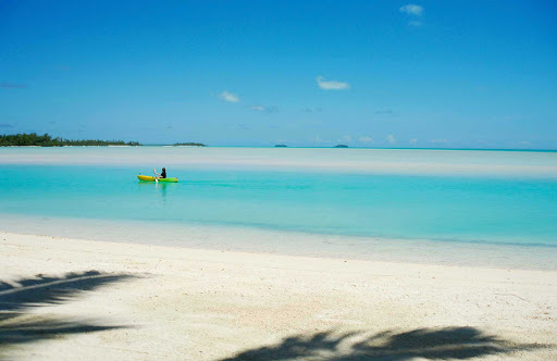 A lone paddler in Akitua Lagoon, on Aitutaki, the Cook Islands.