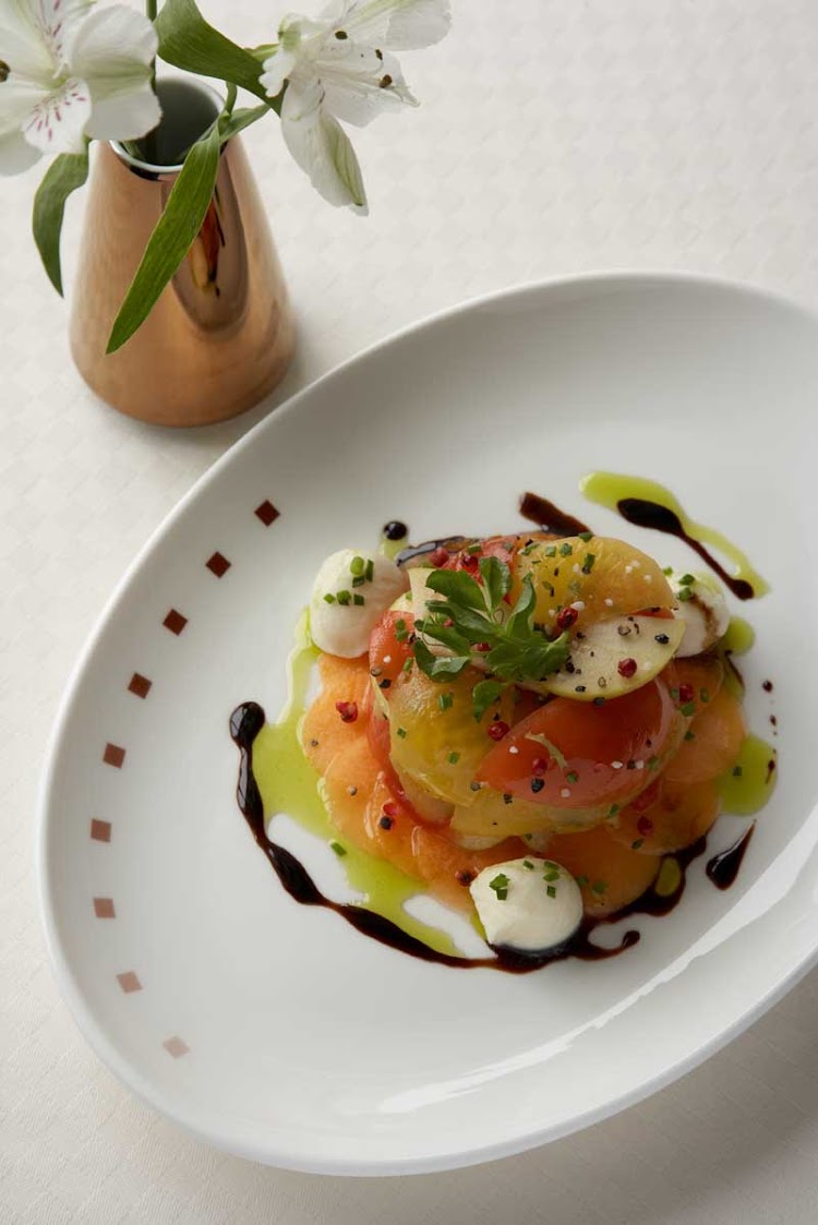 Tomato salad prepared at the Tuscan Grille on your Celebrity Cruises voyage.