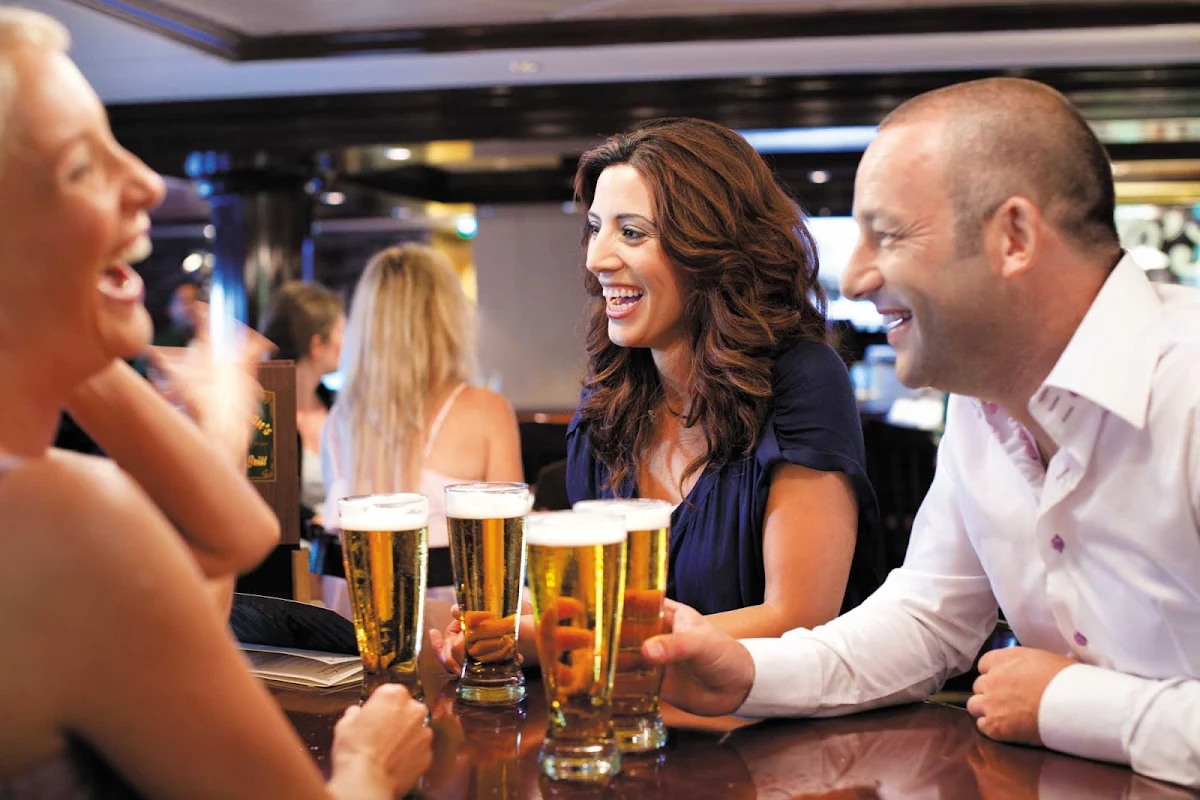 Norwegian-Epic-O'Sheehans-group - Cool off with a brew, dig into some comfort food and meet new people at O'Sheehan's Neighborhood Bar & Grill, an Irish-inspired pub. (This shot was taken on Norwegian Epic.)