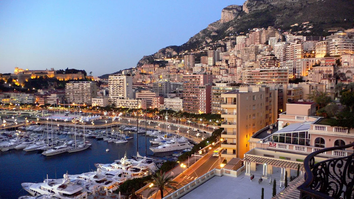 Monte-Carlo-skyline-harbor-at-dusk - View of the Monte Carlo skyline and marina from the Hermitage Hotel. 