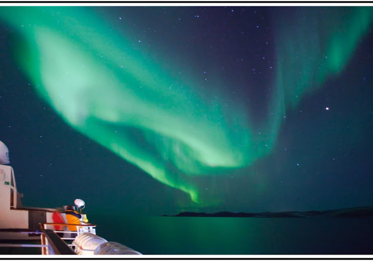 Travel on the Hurtigruten expedition ship Nordlys to see the amazing sky show of the Northern Lights. This aurora was seen over Lofoten, Norway. 