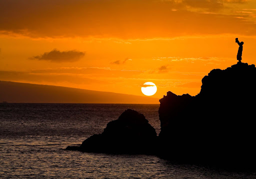 Black-Rock-Lahaina-sunset - A torch lighting ceremony at sunset at Black Rock in Lahaina, Maui.