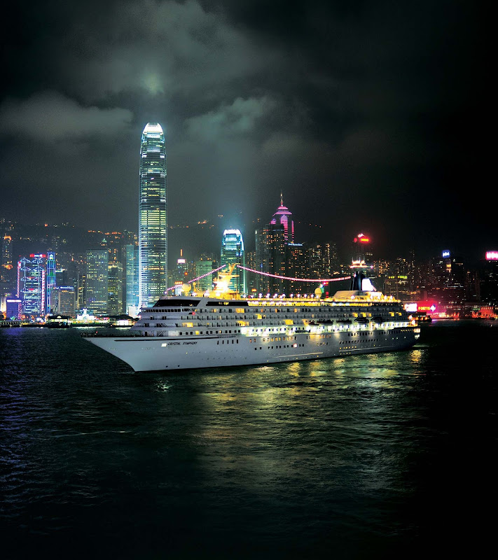 Crystal Symphony glows as it glides through the port of Hong Kong on an evening sojourn.