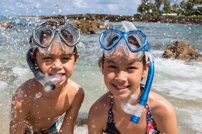 Kids get ready to snorkel on the north shore of Oahu. 