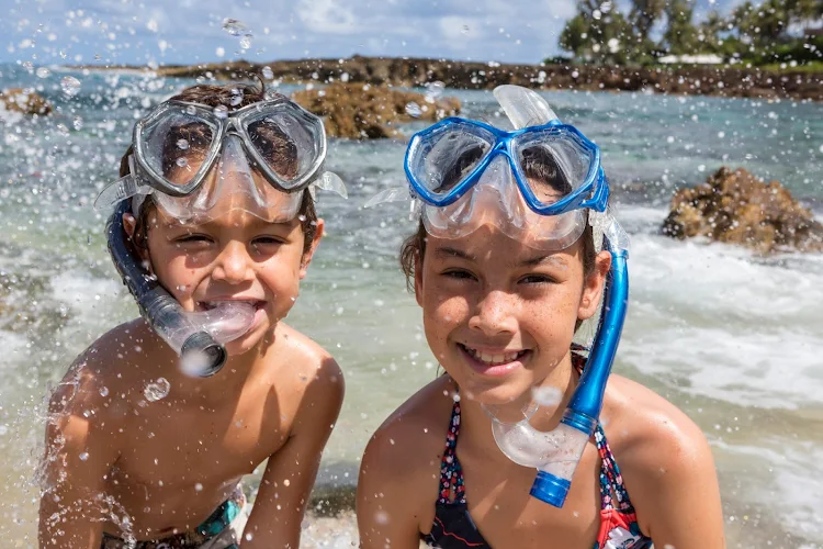 Kids get ready to snorkel on the north shore of Oahu. 