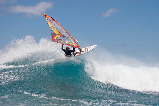 Peter Garzke, a professional windsurfer from Germany, does an aerial off the coast of Honolulu. 