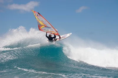 Peter Garzke, a professional windsurfer from Germany, does an aerial off the coast of Honolulu. 