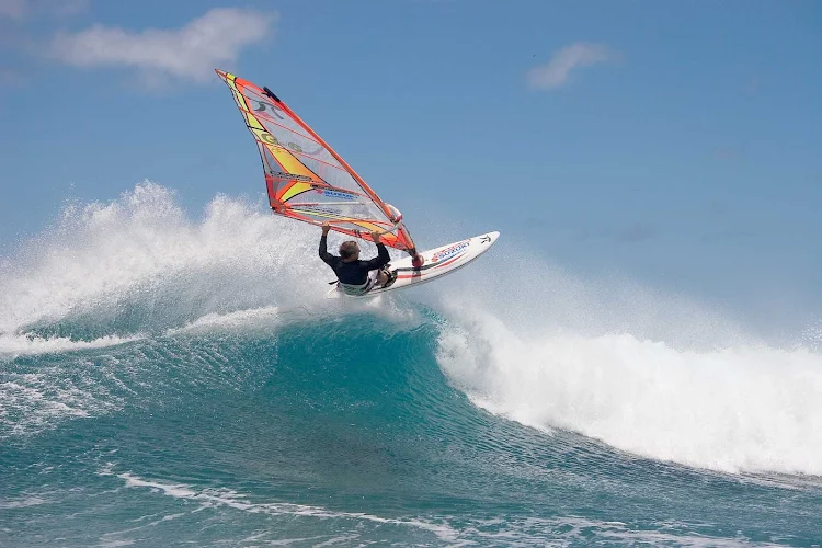 Peter Garzke, a professional windsurfer from Germany, does an aerial off the coast of Honolulu. 