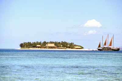The Tui Tai, a sail cruiser, passes by Treasure Island, one of five resort islands in the Mamanuca group. The shot was taken from Beachcomber Island.