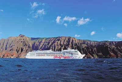 Cruise to Kauai, Hawaii, and experience the beauty of Na Pali Coast's green cliffs and splendid waterfalls.